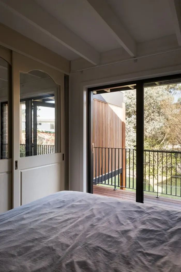 Renovated bedroom with a glazed door opening to a timber-framed balcony, Coledale